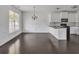 Bright kitchen and dining area with stainless steel appliances and dark hardwood floors at 2377 Proctor Creek Enclave, Acworth, GA 30101