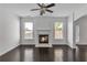 Bright living room featuring a fireplace, hardwood flooring, and abundant natural light at 2377 Proctor Creek Enclave, Acworth, GA 30101