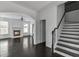 Open-concept living room featuring hardwood floors, fireplace, and staircase at 2377 Proctor Creek Enclave, Acworth, GA 30101