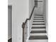 View of the staircase which has dark wood treads and bannister with white risers and stringers at 2377 Proctor Creek Enclave, Acworth, GA 30101