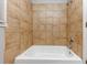 Bathroom showcasing a white tub with light brown tiled walls and neutral paint at 430 Argus Nw Cir, Atlanta, GA 30331