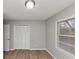 Neutral bedroom showcasing modern vinyl floors, a window, and a closet for ample storage at 430 Argus Nw Cir, Atlanta, GA 30331