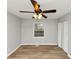 This bedroom is well-lit and includes a ceiling fan, closet, and window for natural light at 430 Argus Nw Cir, Atlanta, GA 30331