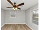 Bright bedroom featuring a ceiling fan and natural light streaming through two windows at 430 Argus Nw Cir, Atlanta, GA 30331