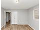 A bright and neutral bedroom with wood flooring, a large window, and double-door closet at 430 Argus Nw Cir, Atlanta, GA 30331