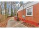 Side view of a red brick and white sided home with a sidewalk and small staircase at 430 Argus Nw Cir, Atlanta, GA 30331