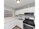 Bright kitchen with white cabinetry, stainless steel range, and durable wood-look flooring at 430 Argus Nw Cir, Atlanta, GA 30331