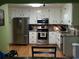 Updated kitchen with stainless steel appliances, granite countertops, and white cabinets, offering both style and functionality at 22 Briar Chase Ct, White, GA 30184