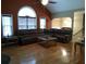 Spacious living room with vaulted ceilings, hardwood floors, large windows, and a comfortable seating arrangement at 22 Briar Chase Ct, White, GA 30184