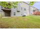 Large backyard featuring green lawn and the home's rear exterior with deck and staircase at 229 Millwheel Dr, Villa Rica, GA 30180