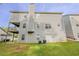 Wide backyard view showing green lawn, back of the home and the deck at 229 Millwheel Dr, Villa Rica, GA 30180
