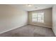Neutral bedroom with window, blinds, and neutral carpeting at 229 Millwheel Dr, Villa Rica, GA 30180