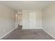 Neutral bedroom with neutral carpet, and two doors at 229 Millwheel Dr, Villa Rica, GA 30180