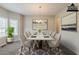 Virtually staged dining area with modern table set and bay windows at 229 Millwheel Dr, Villa Rica, GA 30180