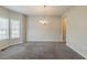 Bright dining room features neutral paint, plush carpet, and modern chandelier at 229 Millwheel Dr, Villa Rica, GA 30180