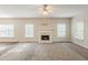 Expansive carpeted living room featuring a fireplace and large windows providing natural light at 229 Millwheel Dr, Villa Rica, GA 30180