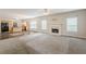 Open-concept living space with fireplace, carpet, and view into the kitchen with an island at 229 Millwheel Dr, Villa Rica, GA 30180