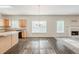 Bright, open-concept living area with wood-look floors connecting to the kitchen and a fireplace at 229 Millwheel Dr, Villa Rica, GA 30180