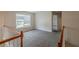 Upstairs loft features neutral walls and carpet, as well as a window at 229 Millwheel Dr, Villa Rica, GA 30180