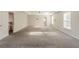 Spacious main bedroom features plush carpet, neutral paint, tray ceiling, and windows at 229 Millwheel Dr, Villa Rica, GA 30180