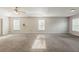 Spacious primary bedroom offers neutral paint, plush carpet, and tray ceiling with ceiling fan at 229 Millwheel Dr, Villa Rica, GA 30180
