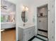 Bathroom vanity with a marble countertop, oval mirror, and a view into main bedroom at 601 Ashley Forest Nw Dr, Acworth, GA 30102