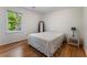 Bedroom featuring wood floors, a window with a view, and simple decor at 601 Ashley Forest Nw Dr, Acworth, GA 30102