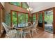 Dining room with large windows, hardwood floors, and access to the screened-in porch at 601 Ashley Forest Nw Dr, Acworth, GA 30102