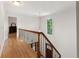Bright hallway features hardwood floors, decorative wrought iron railing, and natural light at 601 Ashley Forest Nw Dr, Acworth, GA 30102