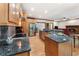 Open kitchen featuring granite countertops, stainless appliances, and seamless flow to the living room with fireplace at 601 Ashley Forest Nw Dr, Acworth, GA 30102