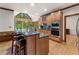 Open kitchen with wood cabinets, granite counters, stainless appliances, breakfast bar, and view to the outdoors at 601 Ashley Forest Nw Dr, Acworth, GA 30102