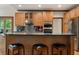 Kitchen with wooden cabinets, granite countertops, stainless appliances and seating at the breakfast bar at 601 Ashley Forest Nw Dr, Acworth, GA 30102