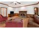 Living room featuring a fireplace, hardwood floors, grandfather clock, and comfortable seating at 601 Ashley Forest Nw Dr, Acworth, GA 30102