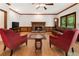 Traditional living room with fireplace, hardwood floors, wood trim, and comfortable seating at 601 Ashley Forest Nw Dr, Acworth, GA 30102