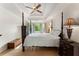 Elegant main bedroom features tray ceiling, four-poster bed, and large windows at 601 Ashley Forest Nw Dr, Acworth, GA 30102