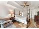 Beautiful bedroom featuring a four-poster bed, tray ceiling, and bright, natural lighting at 601 Ashley Forest Nw Dr, Acworth, GA 30102