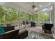 Screened-in porch with a ceiling fan, comfortable seating, and an outdoor view at 601 Ashley Forest Nw Dr, Acworth, GA 30102