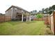 A fenced backyard offering green grass, patio, and exterior of the home at 1143 Park Hollow Ne Ln, Lawrenceville, GA 30043