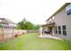Expansive backyard featuring lush green grass, a privacy fence, and a covered patio at 1143 Park Hollow Ne Ln, Lawrenceville, GA 30043