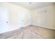 Neutral carpeted bedroom featuring white trim and decorative wall art at 1143 Park Hollow Ne Ln, Lawrenceville, GA 30043