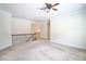 Upstairs living area boasting neutral walls, carpet, and wooden banister at 1143 Park Hollow Ne Ln, Lawrenceville, GA 30043