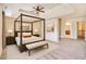 Staged bedroom featuring neutral paint, tray ceilings, recessed lighting, carpet, and a four post bed at 1143 Park Hollow Ne Ln, Lawrenceville, GA 30043