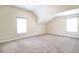 Cozy attic room featuring neutral walls, carpet, and dual windows at 1143 Park Hollow Ne Ln, Lawrenceville, GA 30043