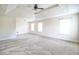 Spacious bedroom with trey ceiling, neutral carpeting, and natural light from three windows at 1143 Park Hollow Ne Ln, Lawrenceville, GA 30043