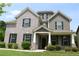 Charming two-story home featuring a well-manicured lawn and an inviting front entrance at 1143 Park Hollow Ne Ln, Lawrenceville, GA 30043