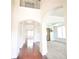 Bright foyer featuring hardwood floors, arched doorways, and wrought iron banister at 1143 Park Hollow Ne Ln, Lawrenceville, GA 30043