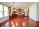 Spacious kitchen with wood floors, a large island, dark wood cabinets, and stainless steel appliances at 1143 Park Hollow Ne Ln, Lawrenceville, GA 30043