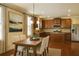 Stylish eat-in kitchen with dark wood cabinets, stainless steel appliances, wood floors, and a breakfast table at 1143 Park Hollow Ne Ln, Lawrenceville, GA 30043