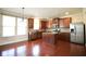 Bright kitchen with stainless steel appliances, wooden cabinets and island, and hardwood floors at 1143 Park Hollow Ne Ln, Lawrenceville, GA 30043