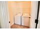 A laundry room featuring white washer and dryer on tile flooring at 1143 Park Hollow Ne Ln, Lawrenceville, GA 30043